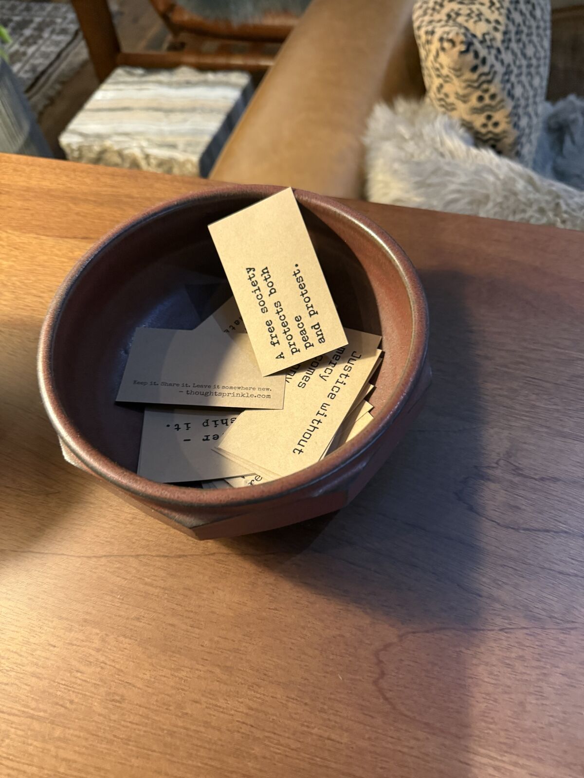 Kraft cards in a clay bowl on a wooden table at the Hewing Hotel